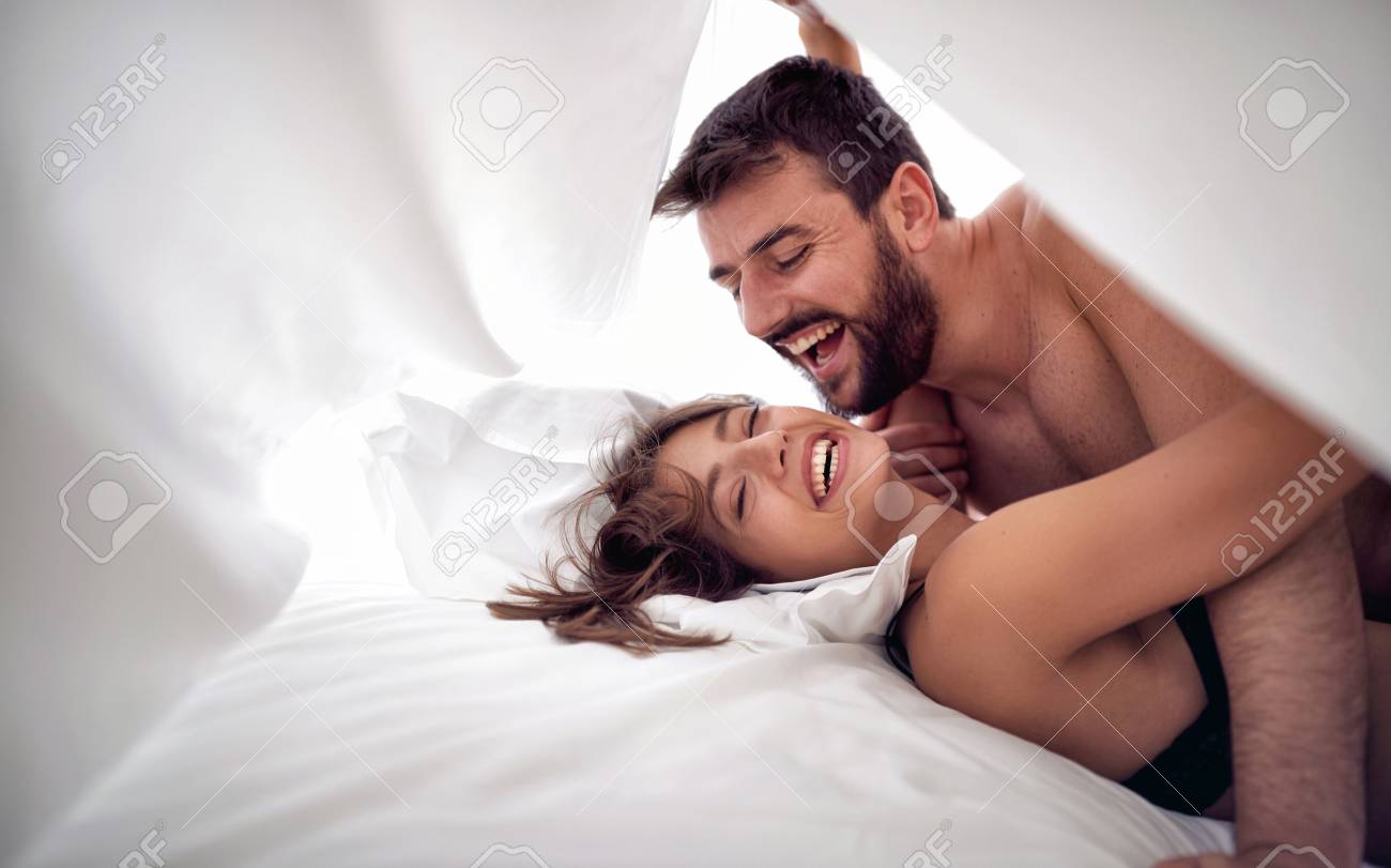 Man and women on bed having sex