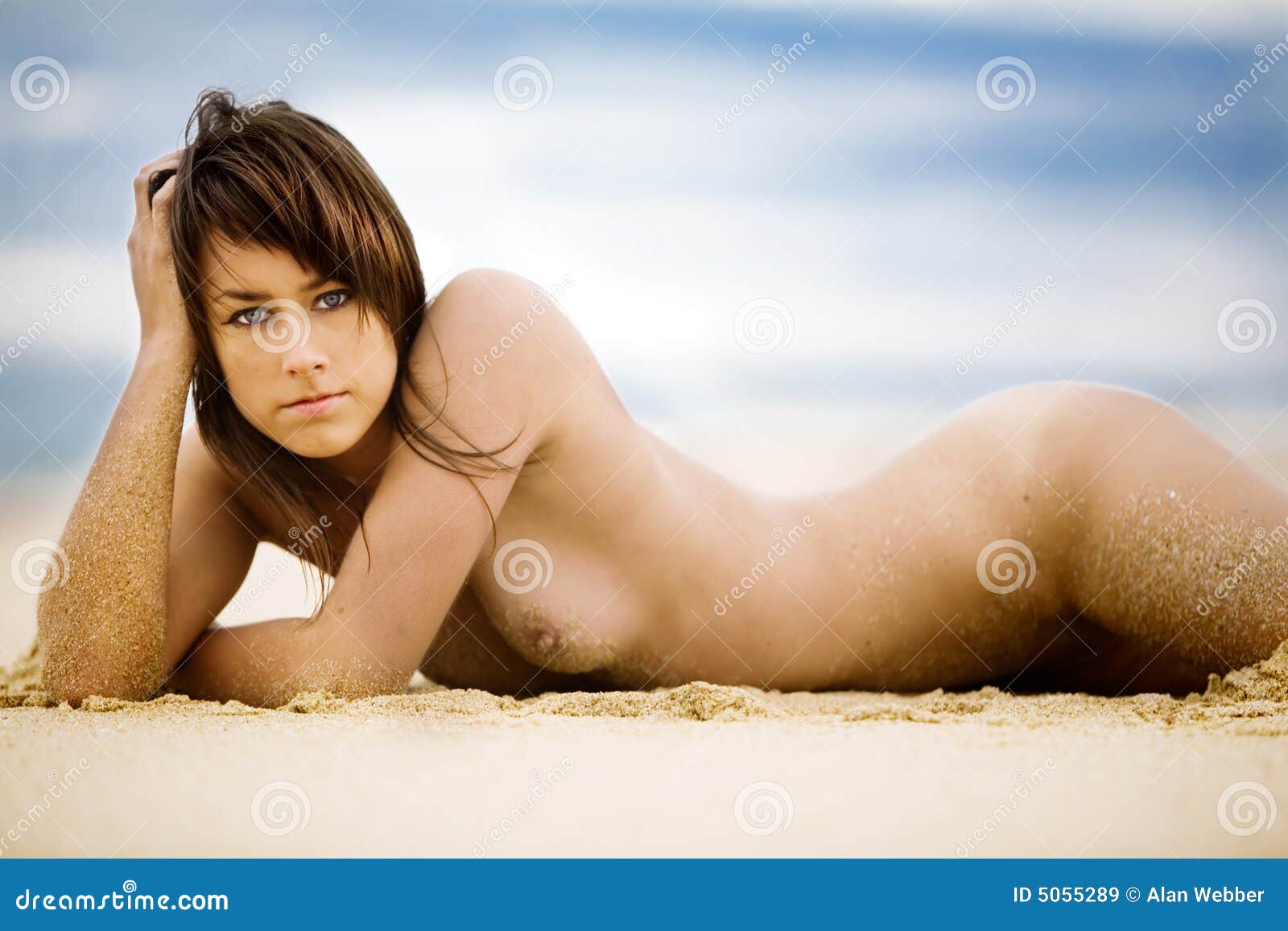 Nude girls laying down on the beach