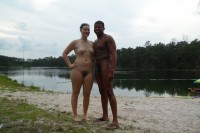 Interracial nude couples on beach