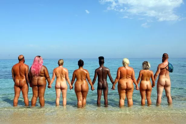 Women get nude at the beach