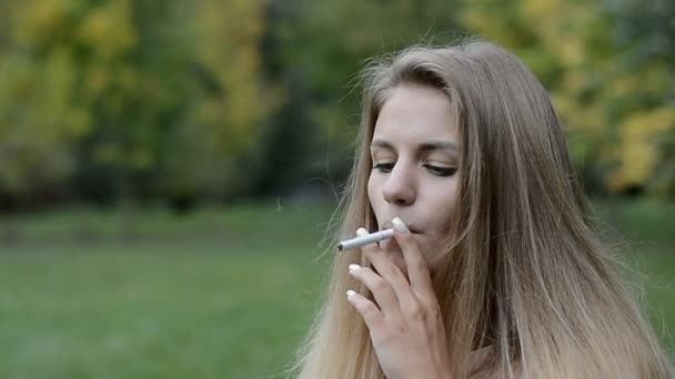 Young blonde teen smoking cigarette
