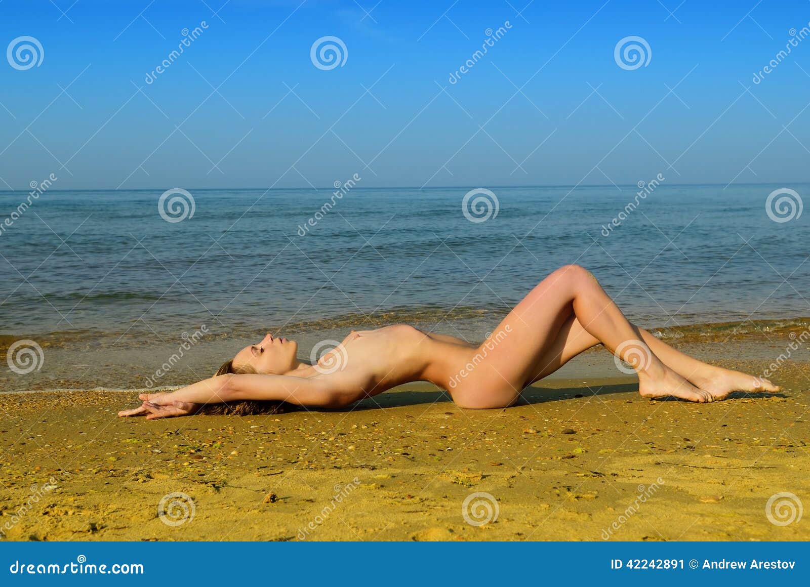 Nude girls laying down on the beach