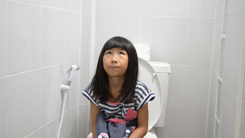 Naked asian girl peeing in toilet